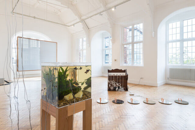 Yuko Mohri, Moré Moré (Leaky): The Falling Water Given #1-3, 2015, Wood, umbrella, hose, PET bottles, rubber glove, bucket, wheel, duster, sponge, pump, acrylic resin, etc. 2725×1758×500mm (×3). Photo: Keizo Kioku. Photo Courtesy: Nissan Art Award